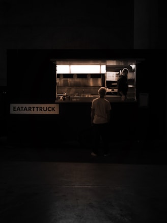 a man standing in front of a food truck