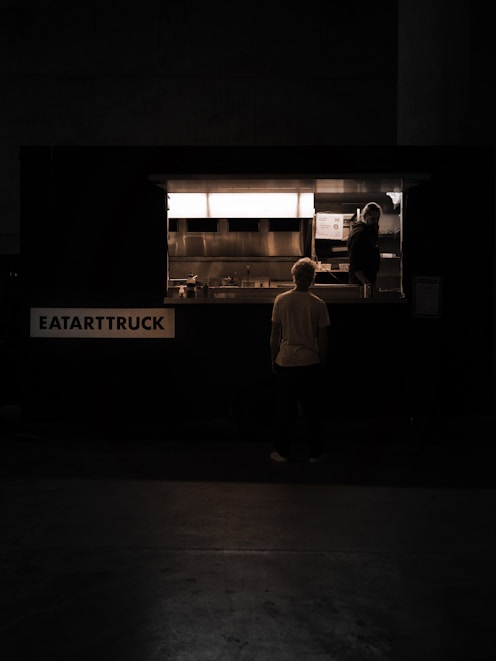 a man standing in front of a food truck