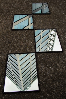 four rectangular black framed mirrors