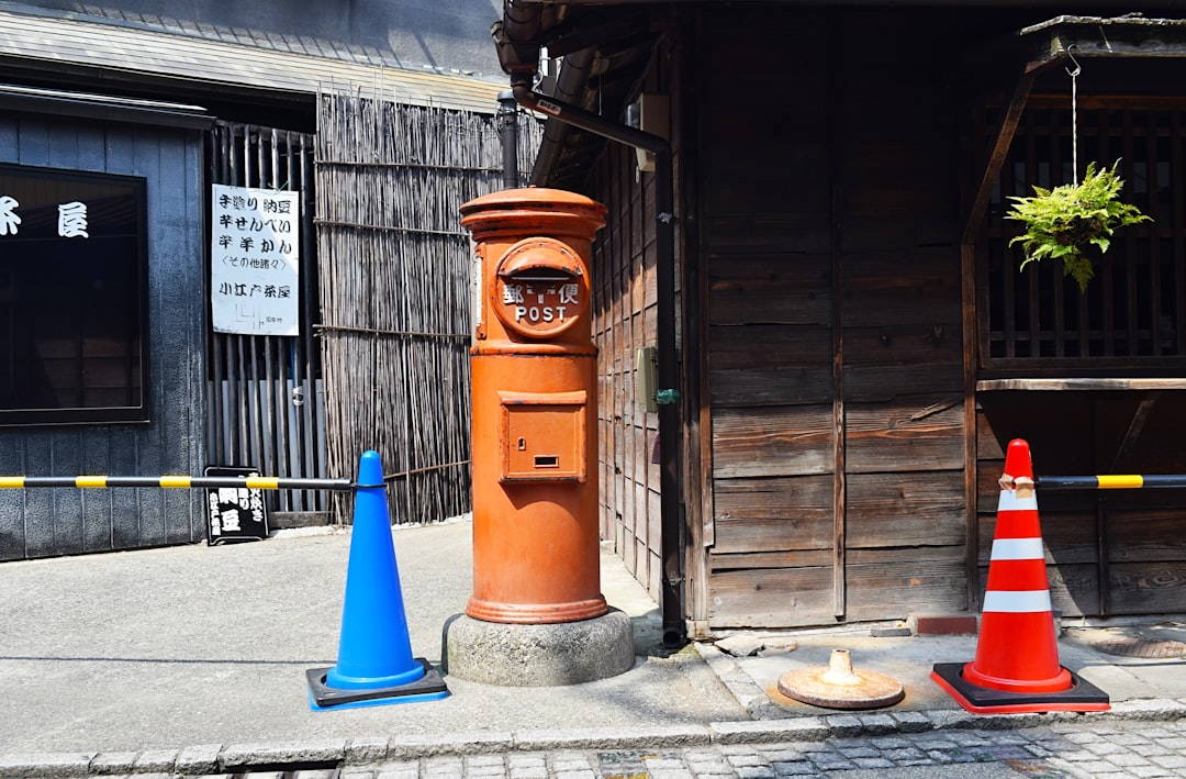 two blue and red safety cones outdoor during daytime