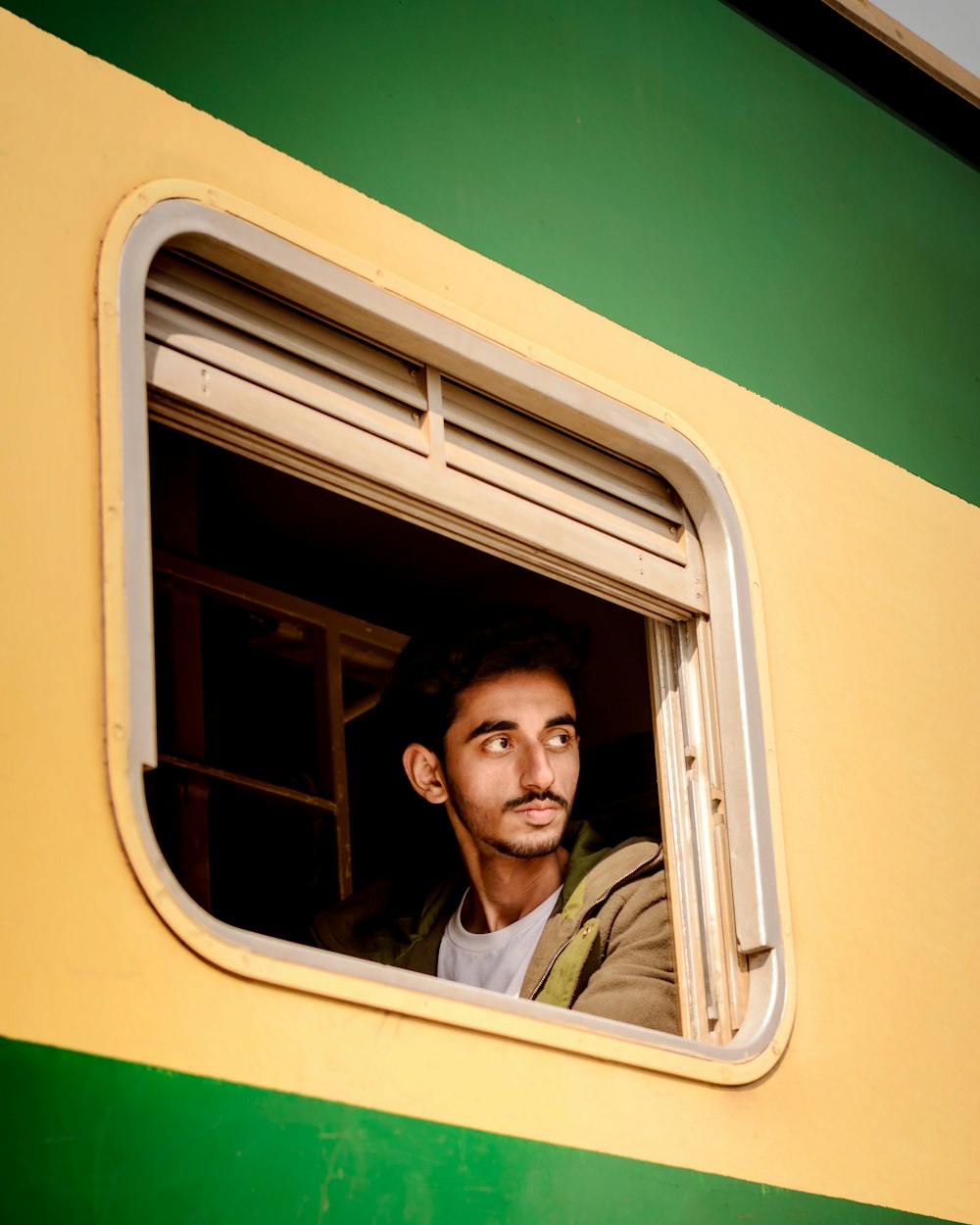 shallow focus photo of man in window