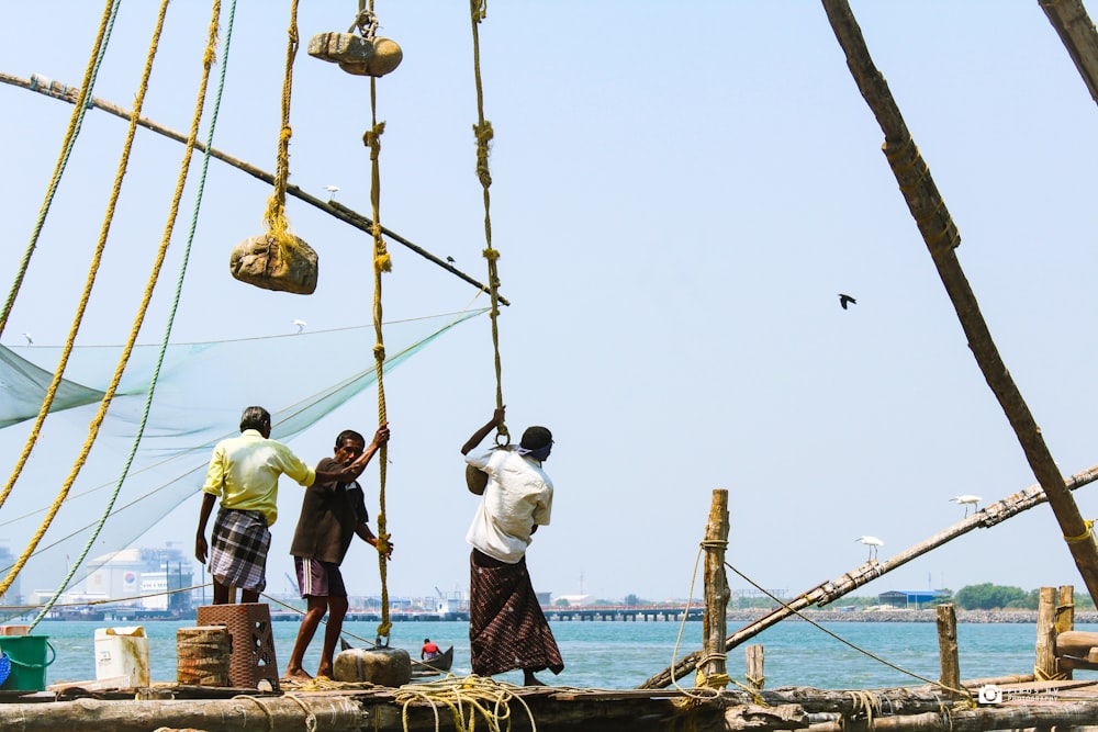 three person riding on boat