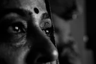 A close-up of a determined eye reflecting fire and steel, capturing the spirit of mental toughness.