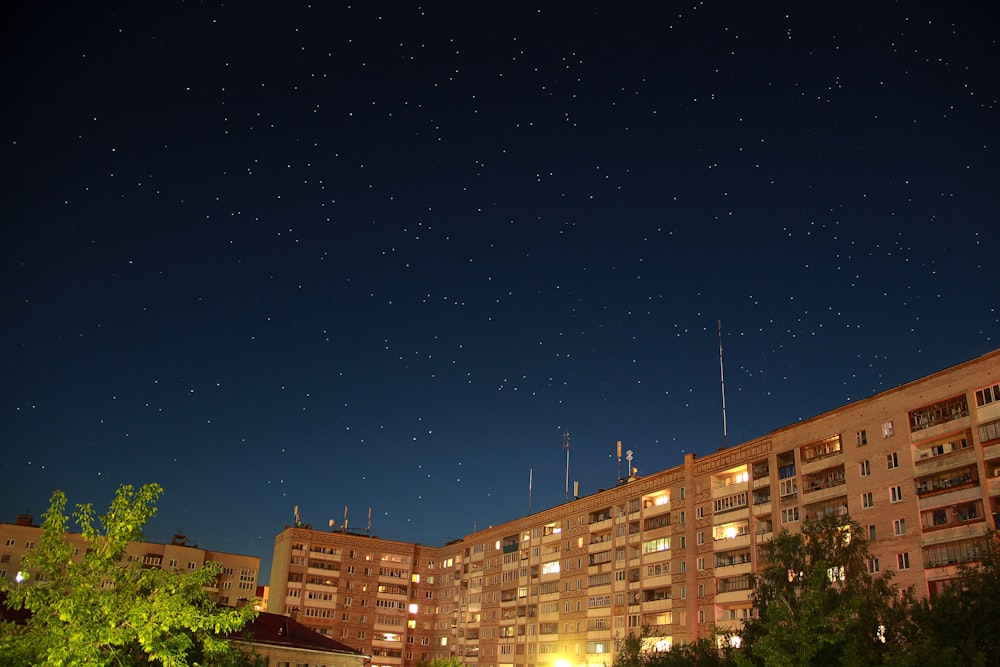 well lighted building under starry night at nighttime