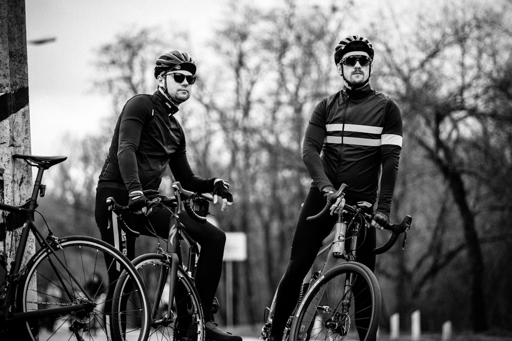 grayscale photography of two cyclers