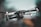 A sleek black drone captured in mid-air, with detailed focus on its camera and hardware. The background is a soft blur, emphasizing a smooth bokeh effect and providing a sense of motion.