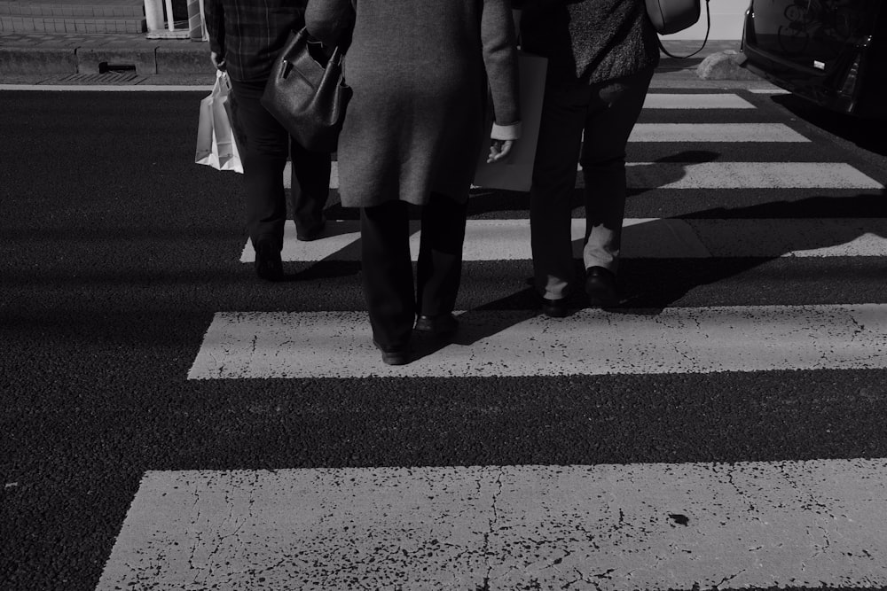 three person on pedestrian lane