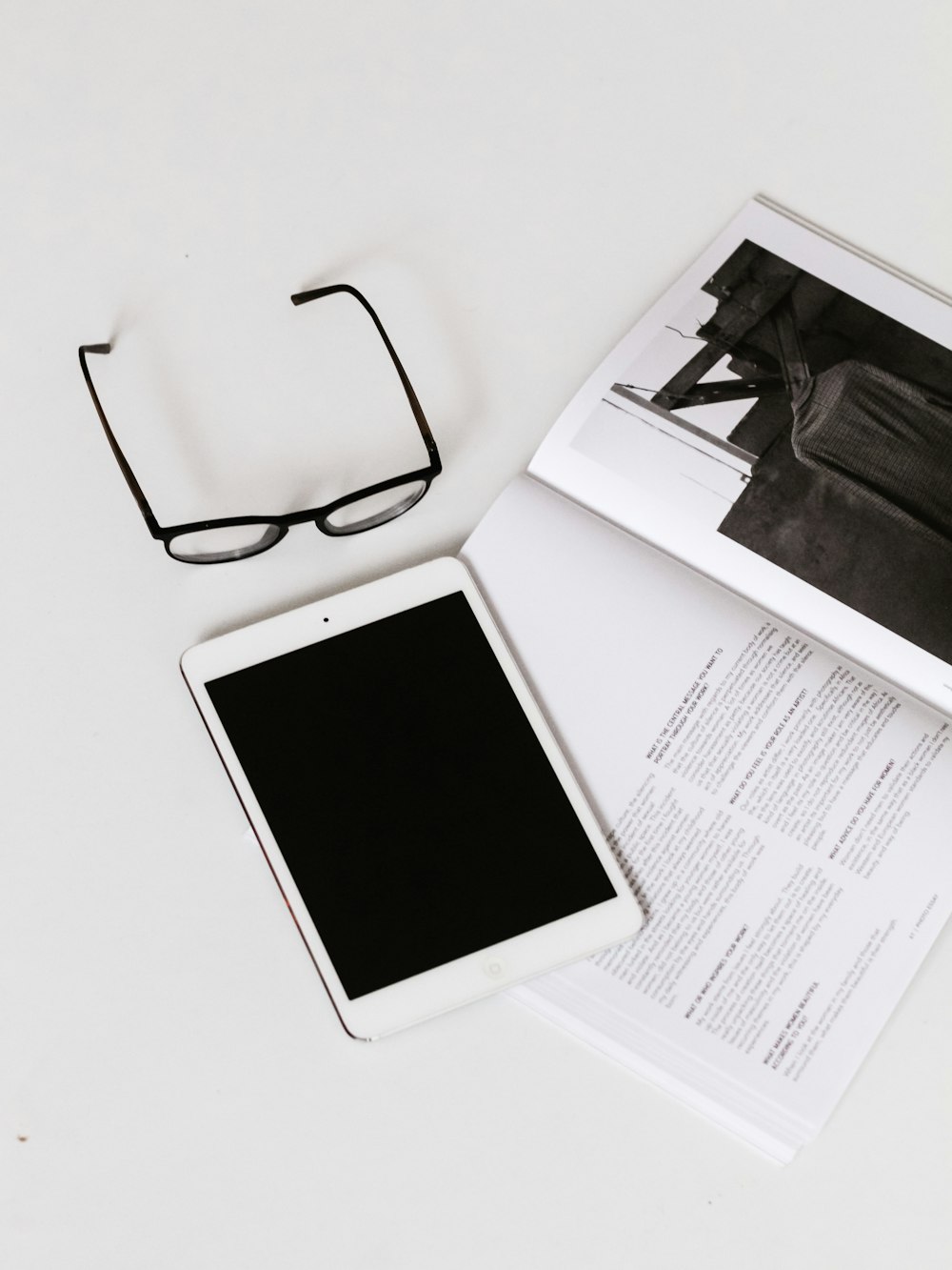 eyeglasses with black frames and white iPad