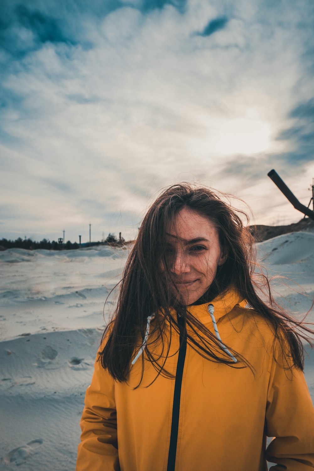 woman in yellow zip-up jacket standing on snow