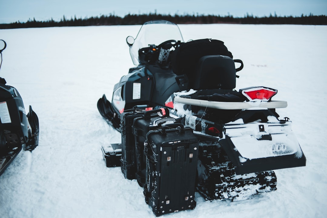 black containers beside snowmobile