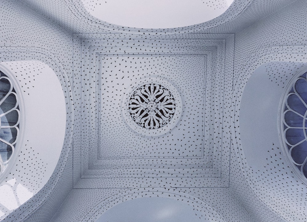 the ceiling of a building with three circular windows