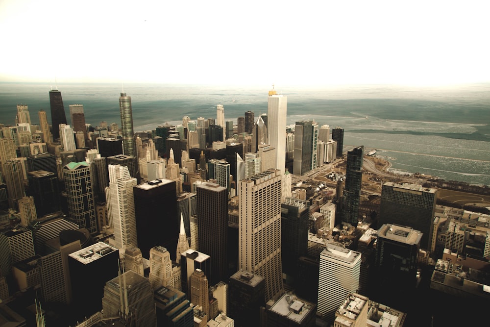 aerial photo of buildings near body of water during daytime