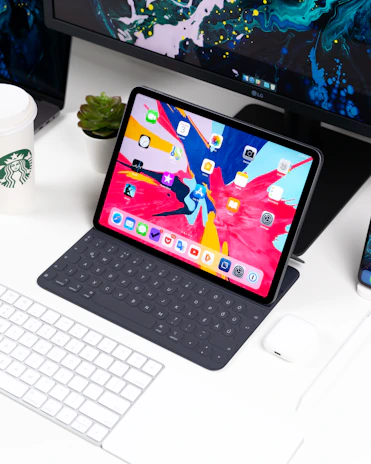 A vibrant, modern workspace with a person browsing a colorful, engaging blog on a tablet.
