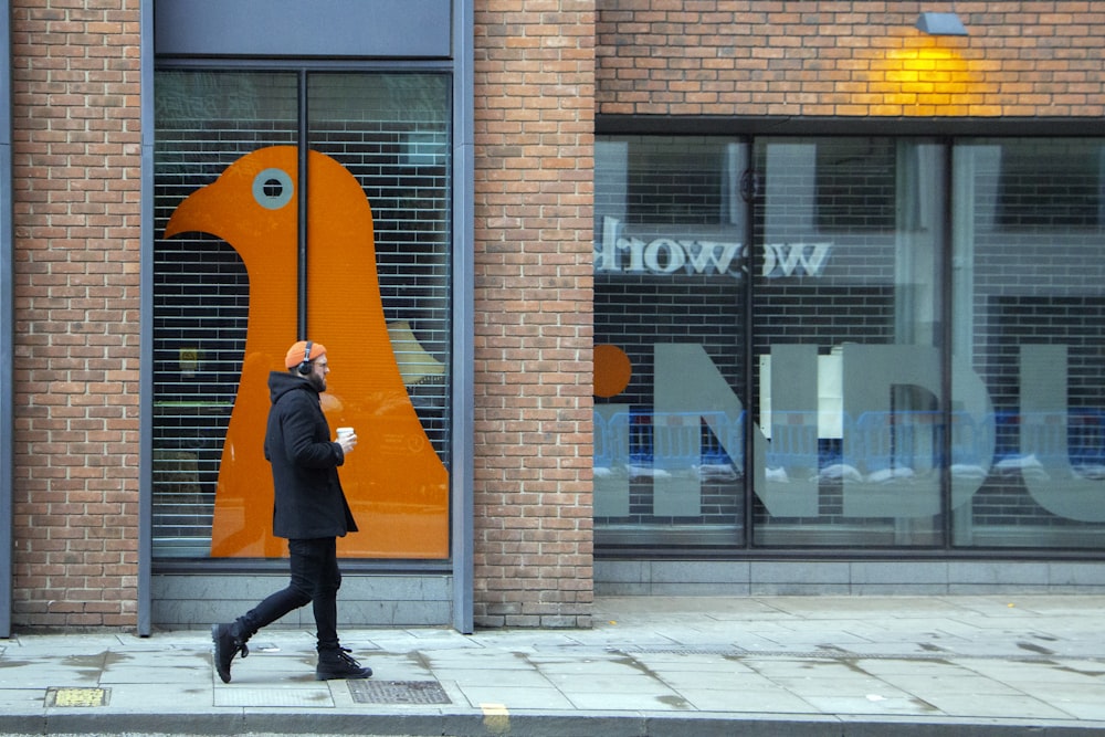 man walking on street during daytime