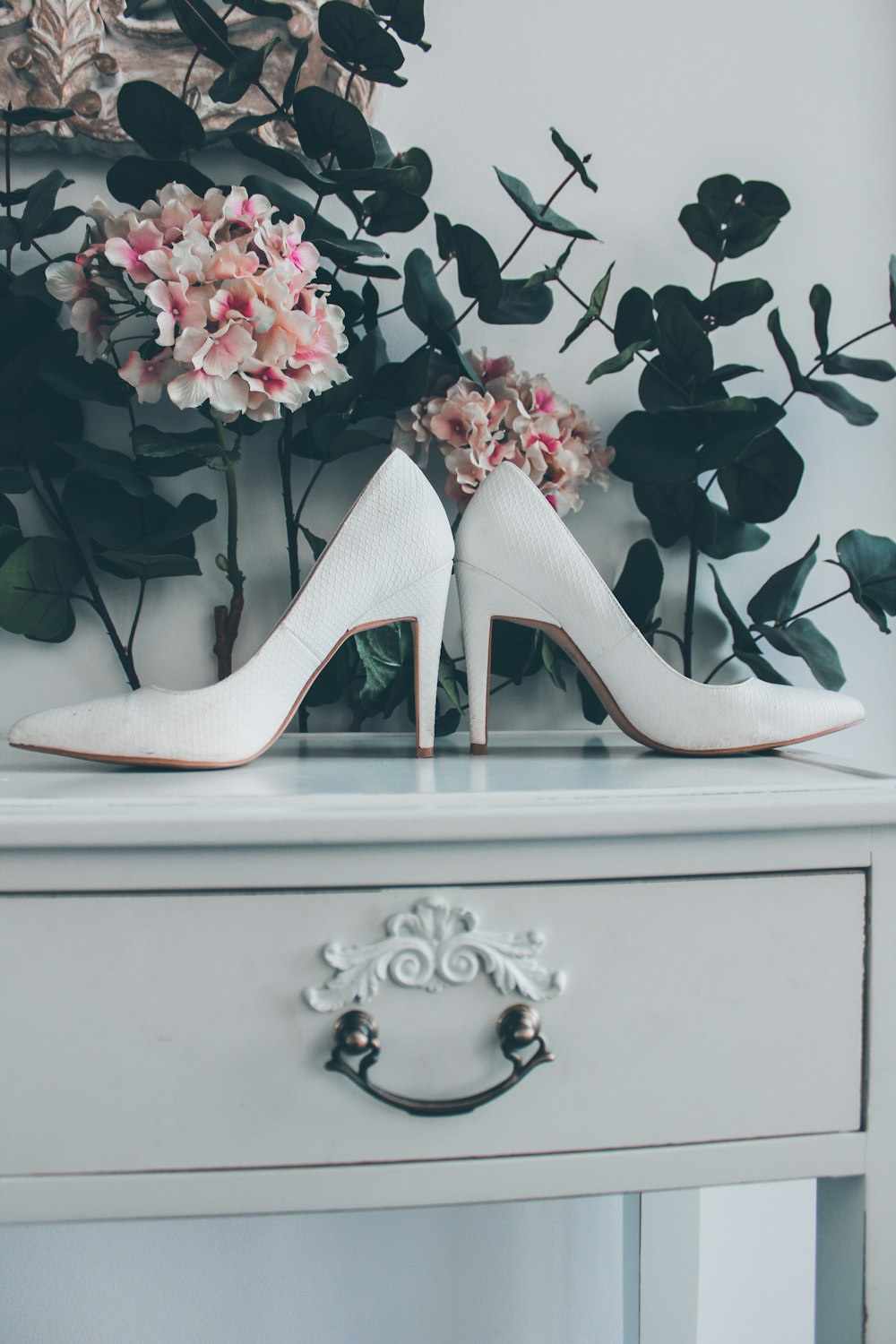 white leather sandals on cabinet