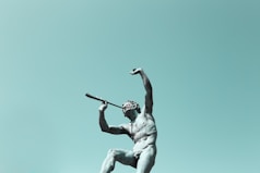 man using musical instrument statue
