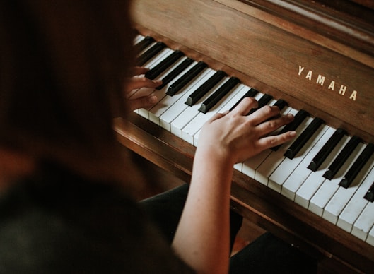 woman playing Yamaha piano