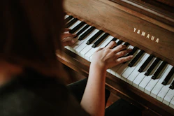woman playing Yamaha piano
