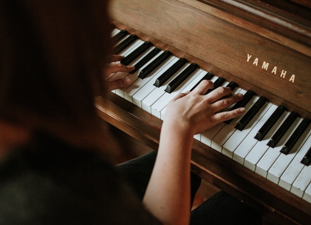 woman playing Yamaha piano