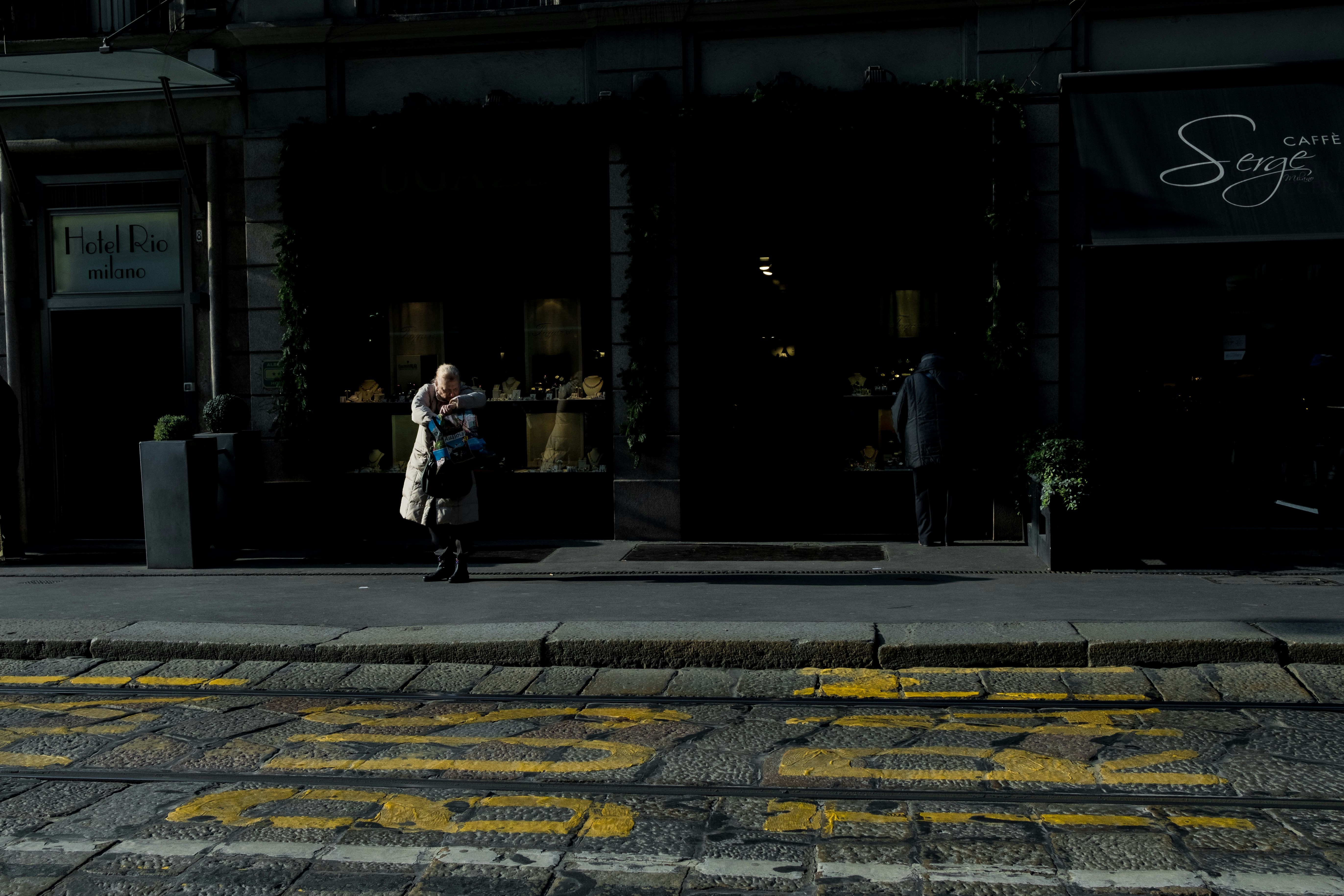 woman standing on sidewalk during daytime