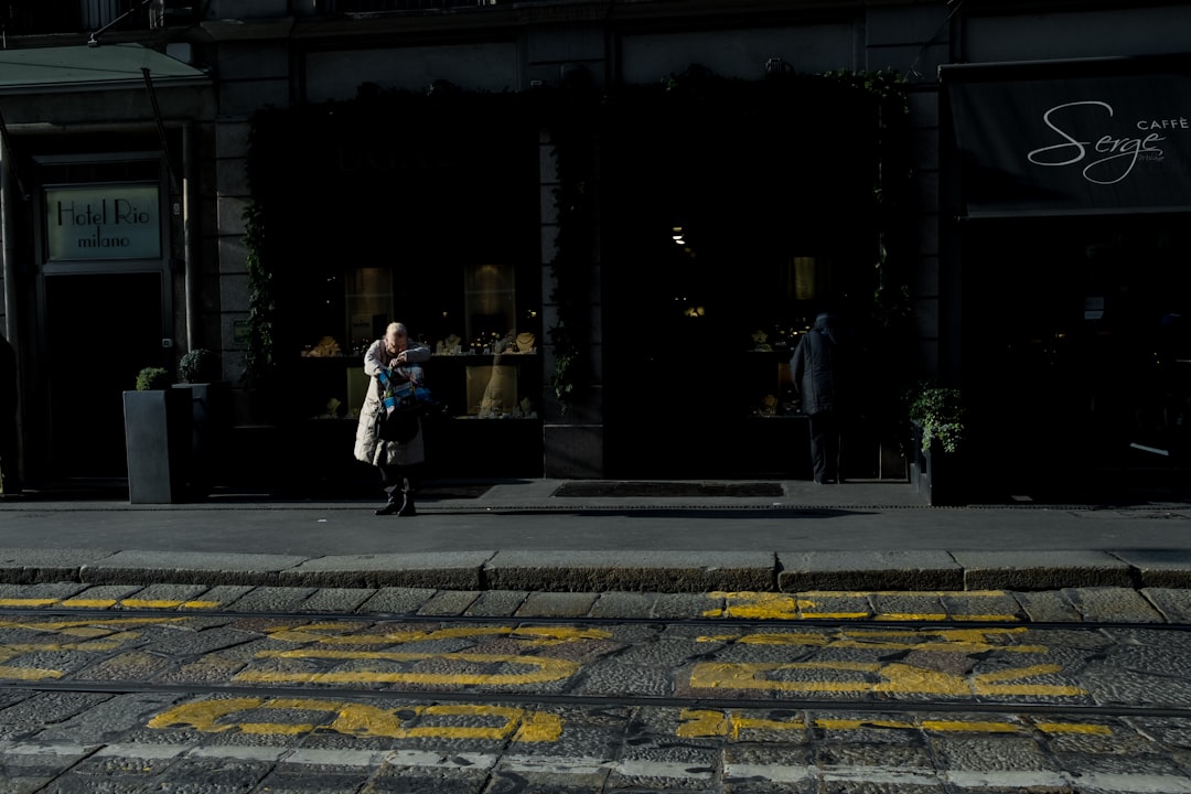 woman standing on sidewalk during daytime