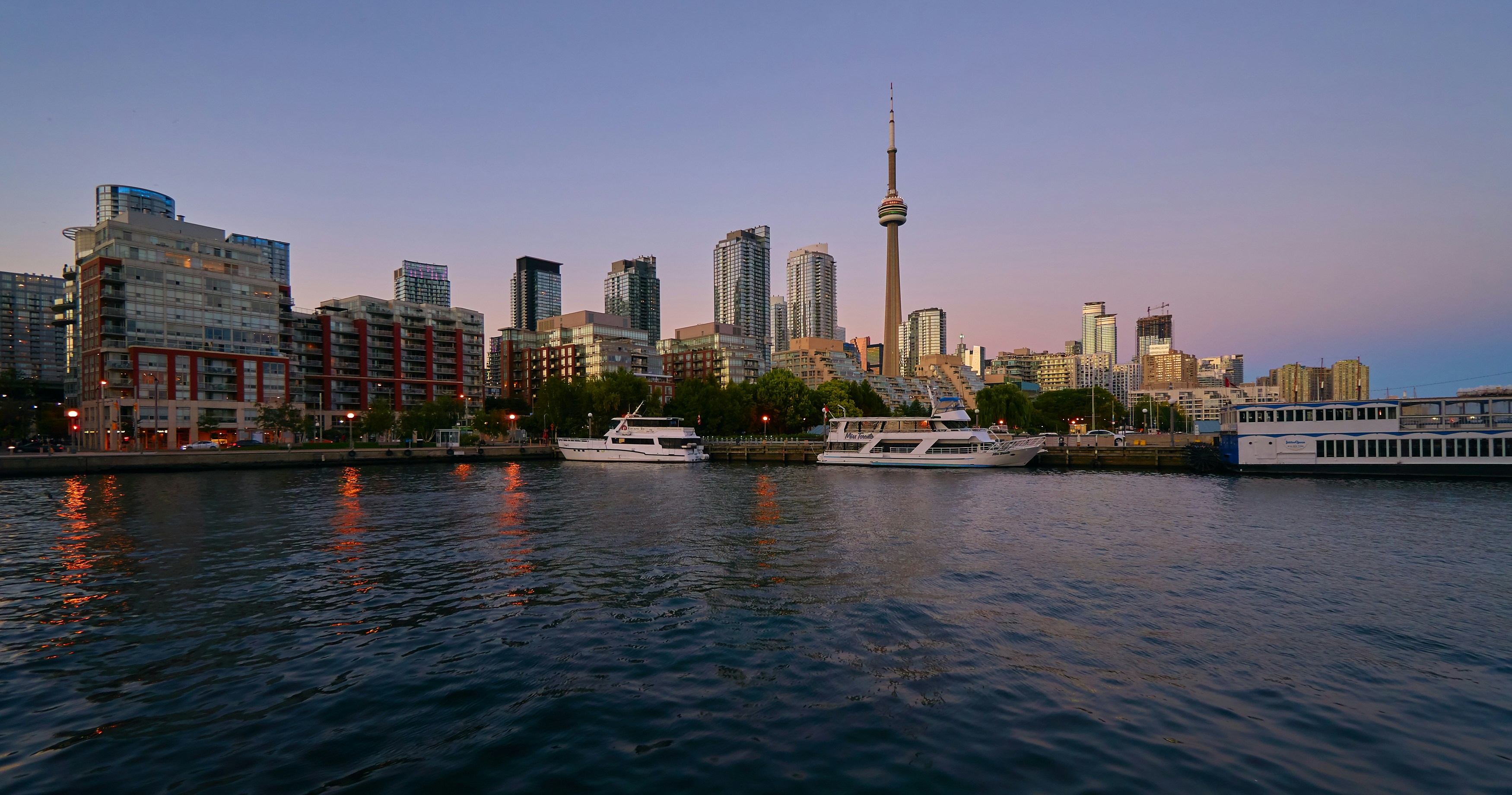 yacht docked near high rise buildings
