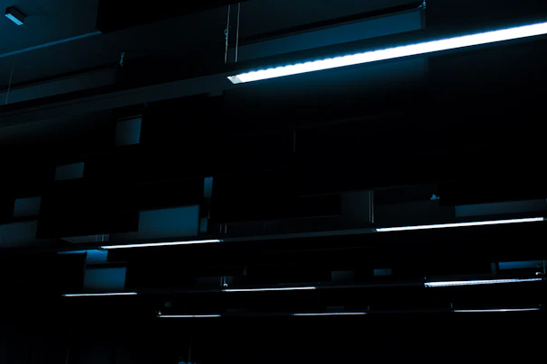A factory floor illuminated by rows of sturdy LED fixtures casting a bright, focused light.