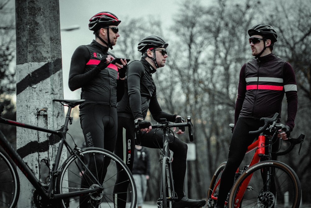 3 men on bikes talking