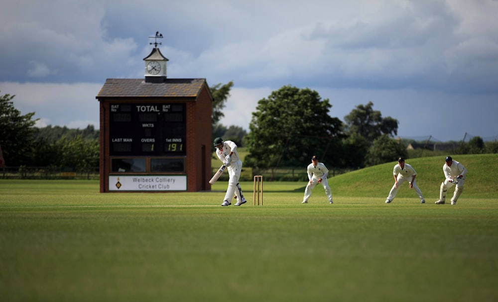 group of person playing cricket