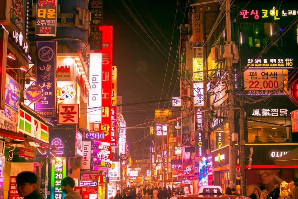 people walking between buildings during night time