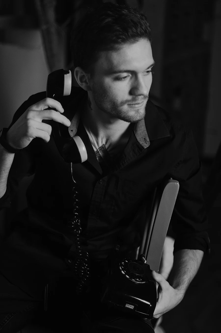 A man answering a telephone, black and white