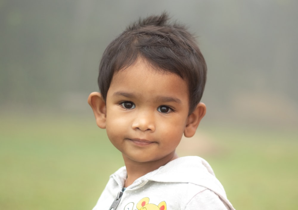 portrait of boy wearing white hoodie top