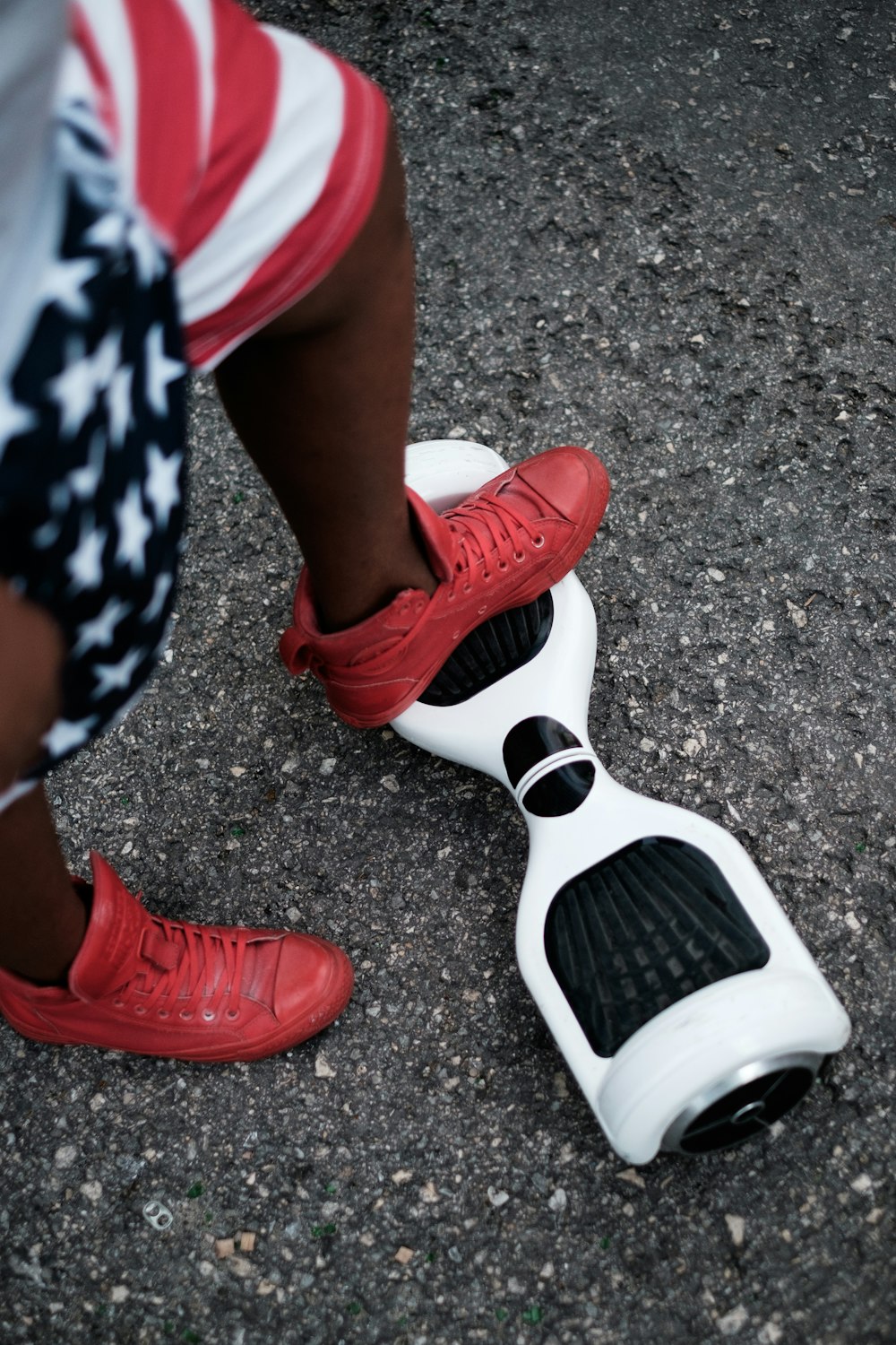 person riding self balancing board on concrete pavement