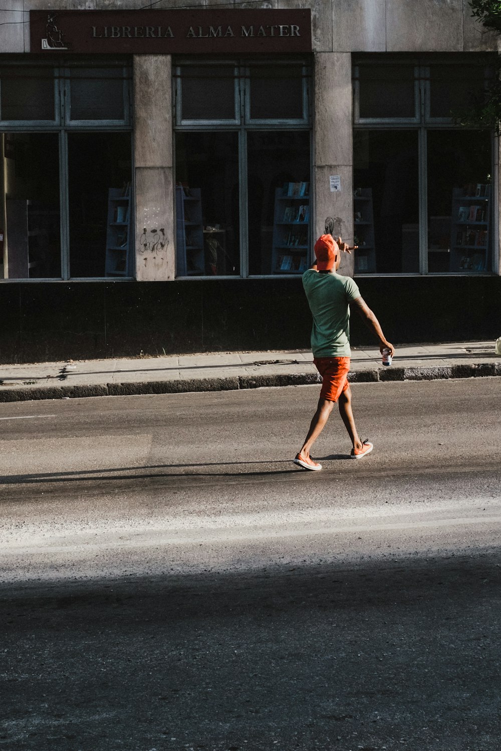 man walking on road near building