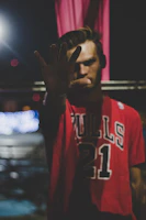 Action shot of a custom football jersey with personalized name and number, highlighted under stadium lights.