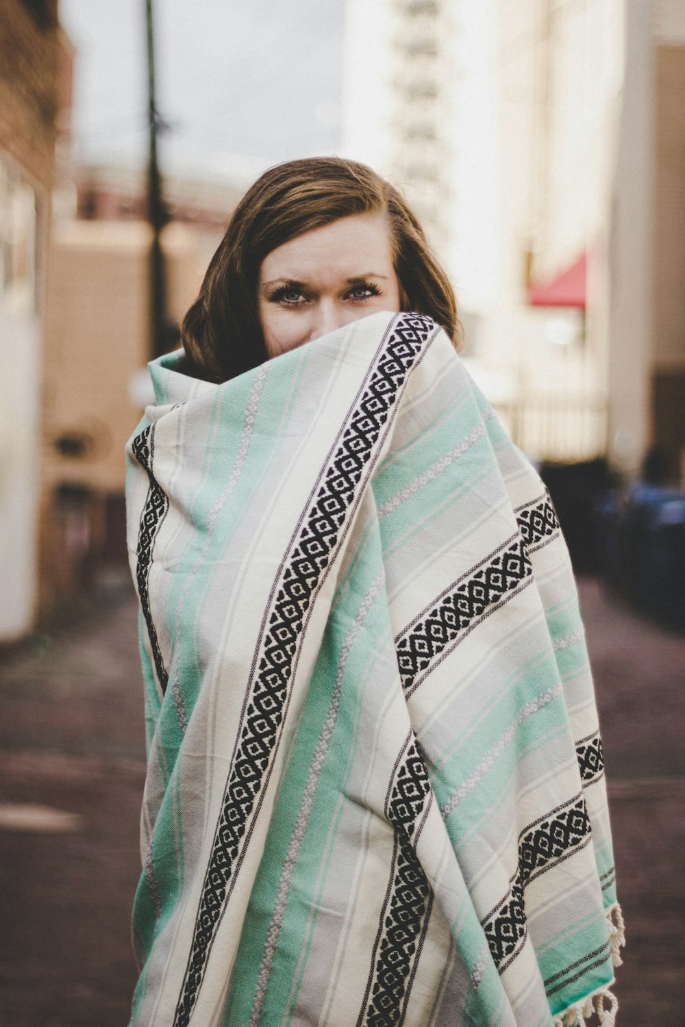 woman covering her body of teal blanket