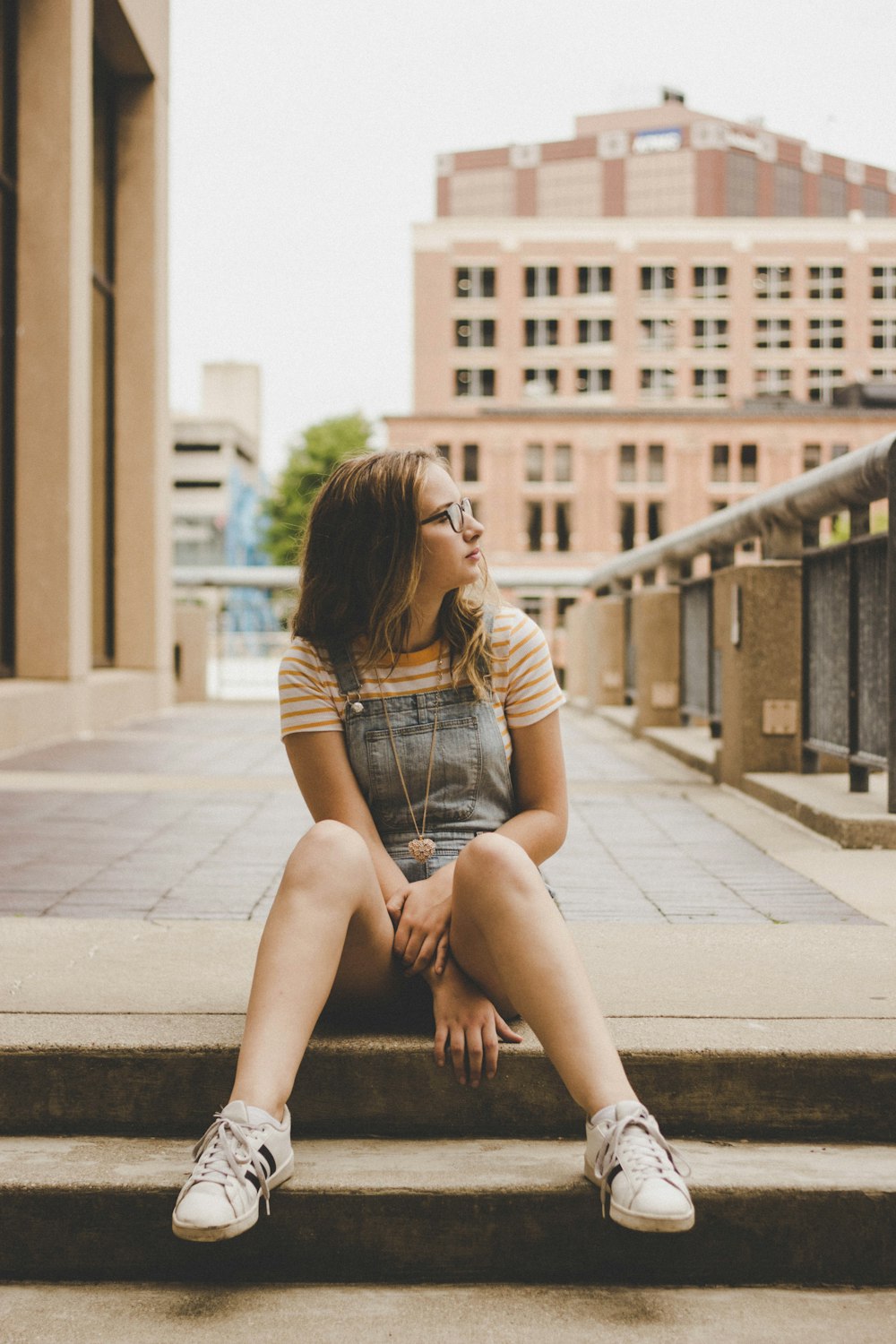 selective focus photo of woman wearing blue dungaree