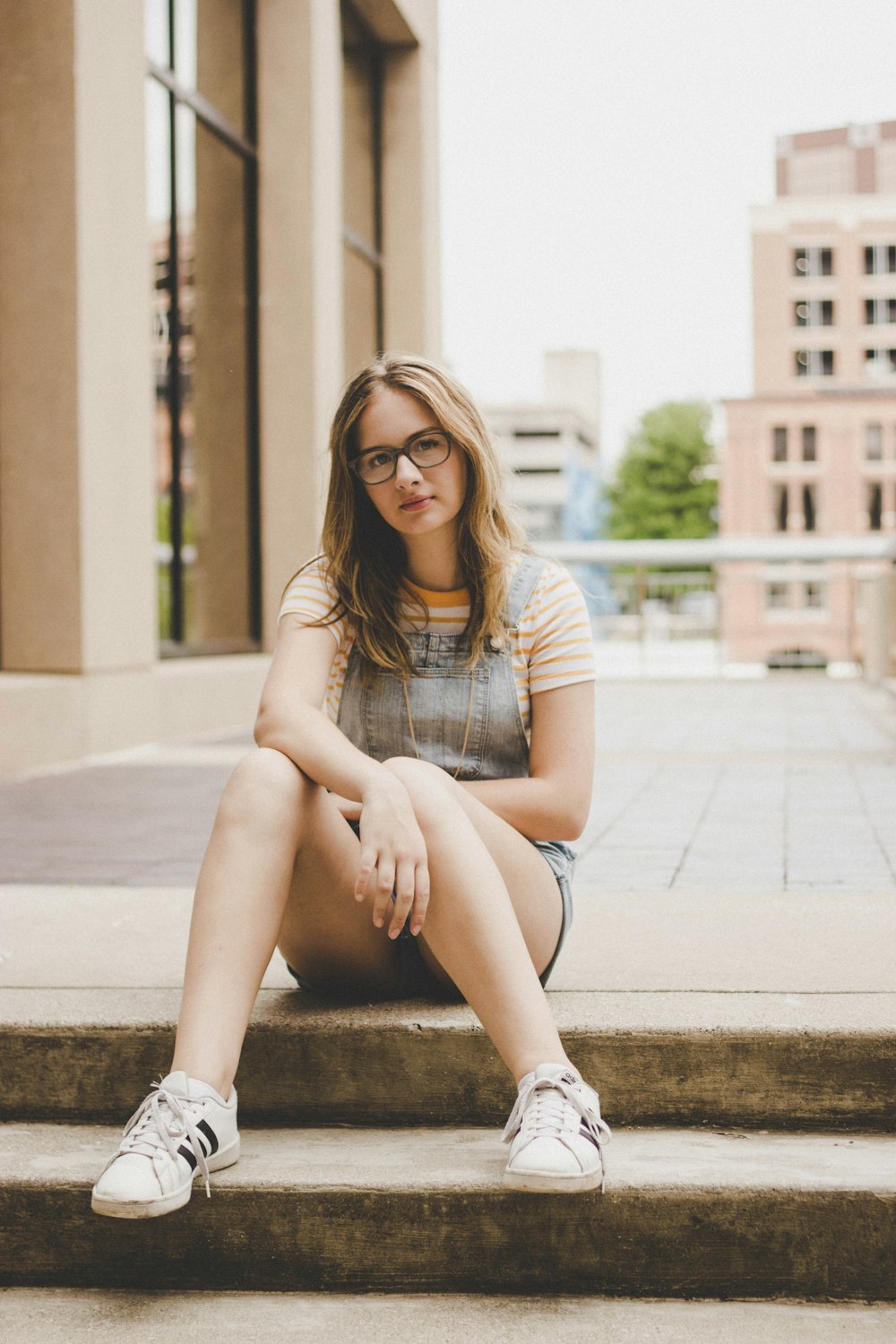 close-u photography of woman sitting on stairs