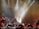 A lively dance troupe performing on stage with colorful lighting.