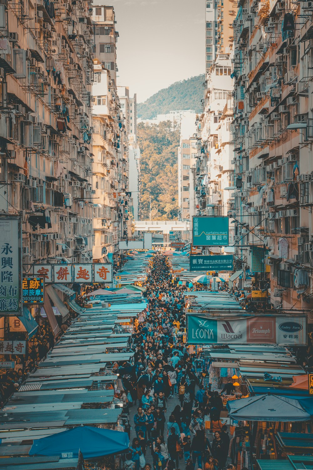 people in market beside high rise buildings