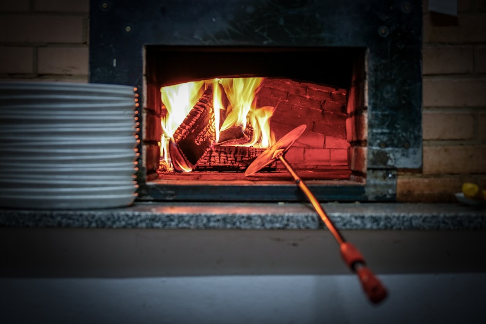 lighted fireplace beside white plates