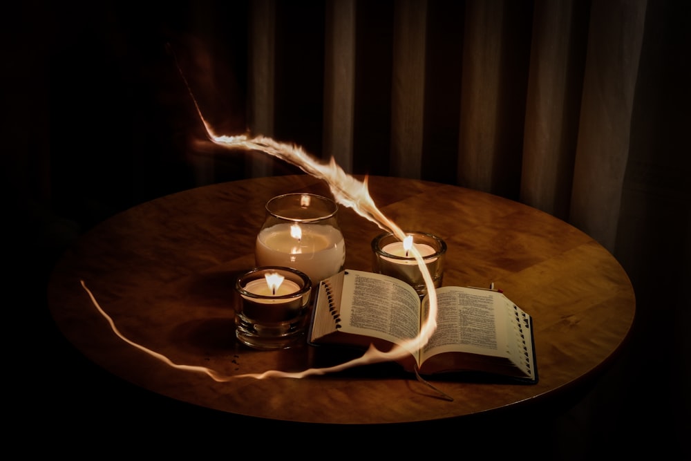lighted candles beside book