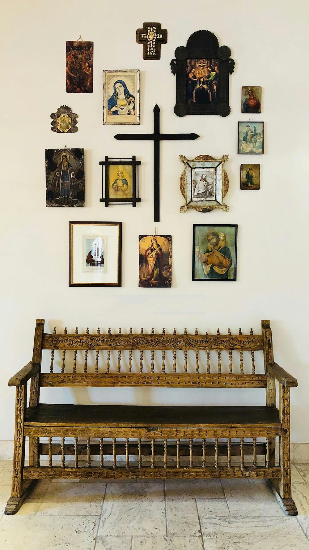 brown wooden bench with religious wall decors