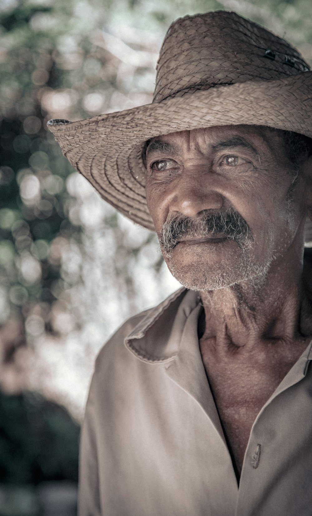 portrait of man waering brown wicker hat