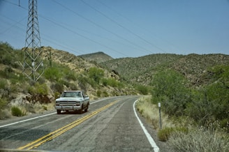 Classic vintage car driving along Route 66 with desert landscape