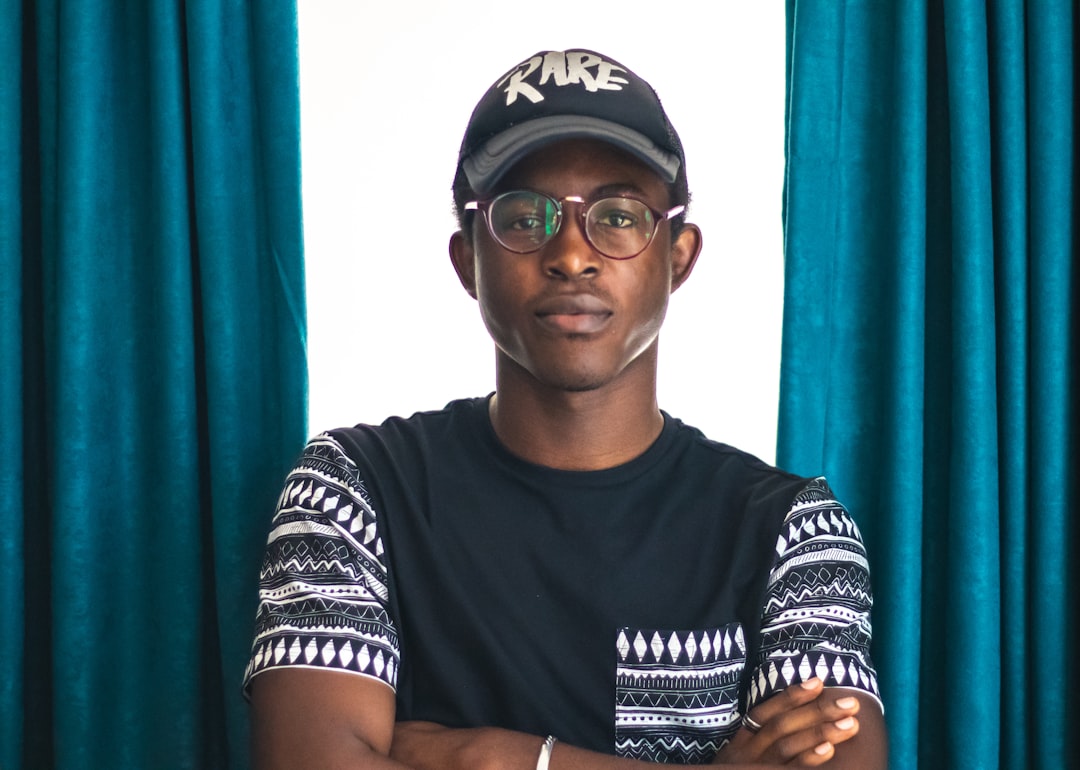 man wearing black Rare-printed cap