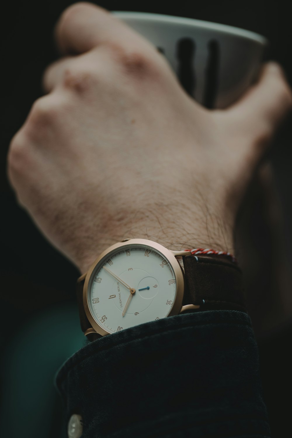 white wristwatch with brown strap