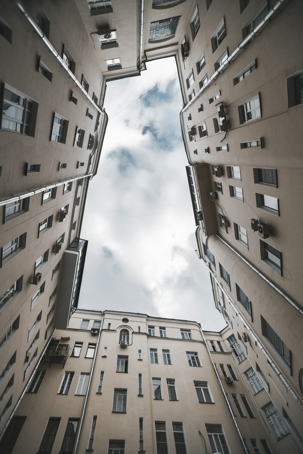 brown concrete building under white clouds