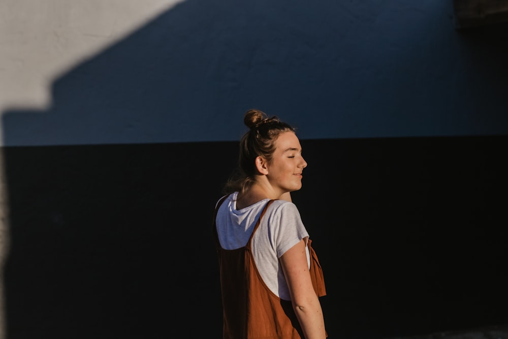 woman wearing white shirt and brown spaghetti-strap top