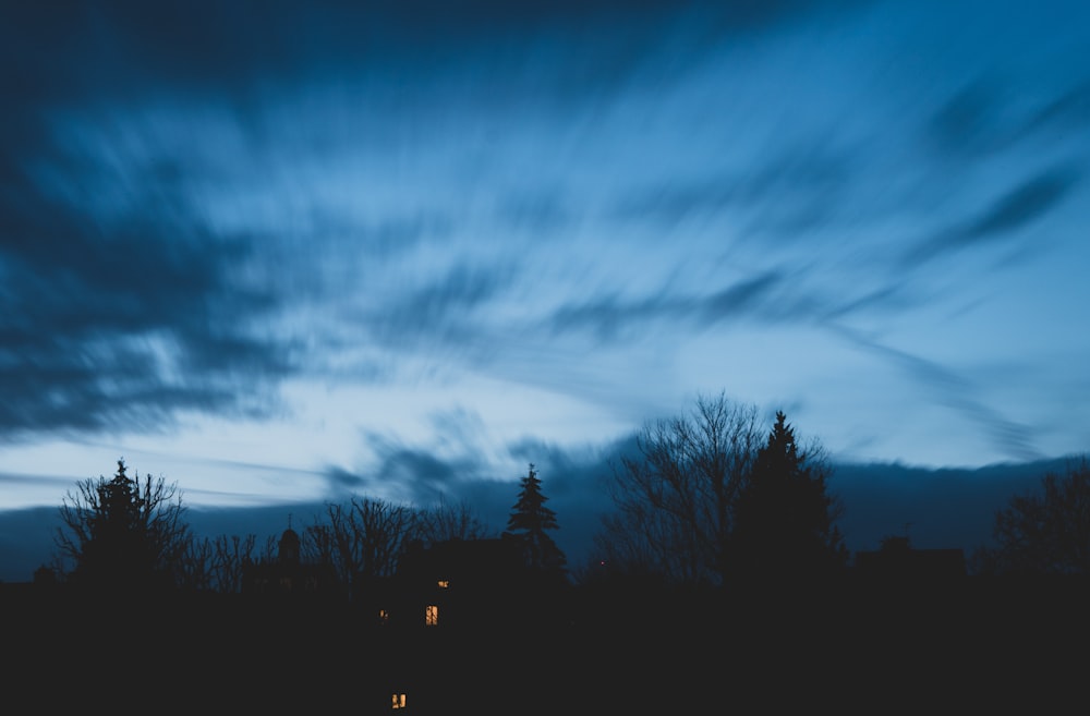 grey cloudy sky over lighted house